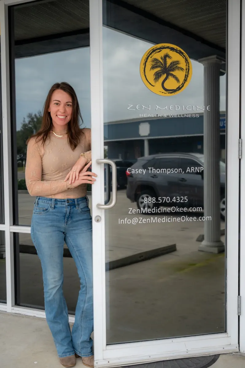 Casey Thompson, APRN, at the front door of Zen Medicine Okeechobee